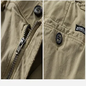 Close-up detail showing the durable metal zipper and fabric texture of khaki cargo pants.