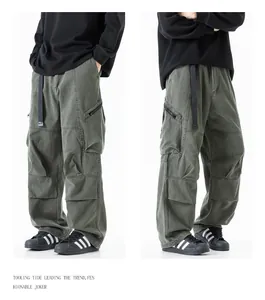 Macro view of olive green techwear cargo pants with multiple functional pockets for men.