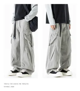 Macro view of side cargo pockets and durable cotton fabric on grey utility pants