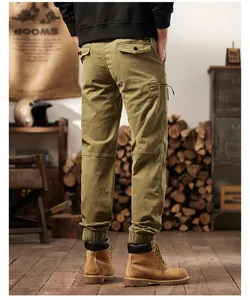 Detailed view of men's retro olive green cargo pants with multi-pockets and jogger cuffs