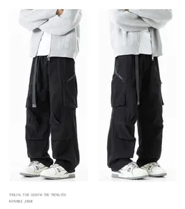 Details of black cargo pants with multiple pockets and loose straight-leg fit