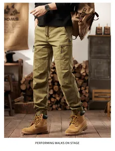 Male model wearing American retro khaki multi-pocket cargo pants in a rustic studio