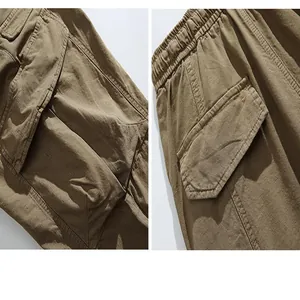 Macro detail view showing the multi-pocket design and elastic waist of khaki cargo pants