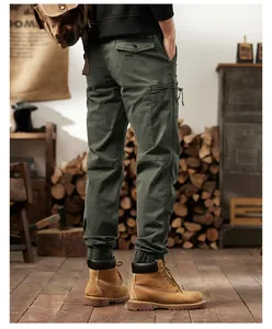 Back view of men's American vintage green cargo joggers with multiple pockets and cuffed ankles