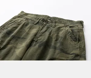Detailed close-up of camouflage cargo pants waistband with button and stitching