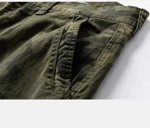 Close-up detail of slanted pocket on camouflage cargo pants with sturdy stitching