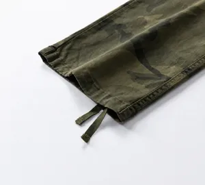 Close-up detail of vintage camouflage cargo pants leg with adjustable drawstring cuff