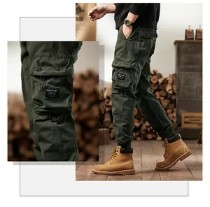 Detailed view of dark green multi-pocket cargo pants for men in a vintage outdoor style