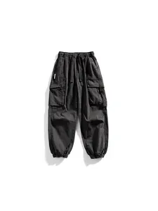 Men's dark grey techwear cargo pants with multiple functional pockets and drawstring waist