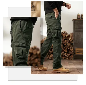 Detailed side view of men's dark green multi-pocket cargo pants in a vintage cabin.