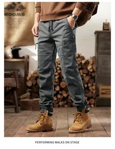 Detailed view of men's vintage multi-pocket cargo pants in dark grey color