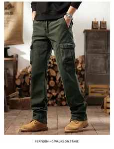 Men's retro dark green multi-pocket cargo pants in a rustic outdoor studio setting.