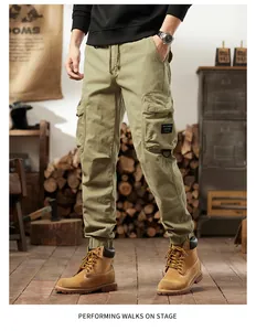 Detail of men's olive green cargo pants with multi-pockets and drawstring waist