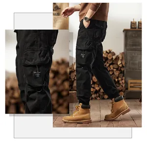Detail shot of black multi-pocket cargo joggers with tapered cuffs in retro outdoor style