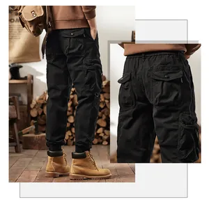 Detail view of men's vintage multi-pocket black cargo pants with tapered cuffs