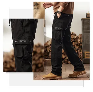 Close-up detail of men's American vintage black multi-pocket cargo pants in a rustic setting