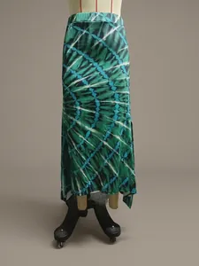 Detail view showing the green tie-dye pattern on an asymmetrical split maxi skirt for women