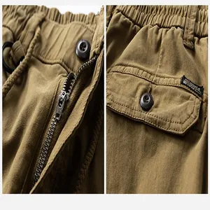 Macro detail of men's vintage outdoor cargo pants showing metal zipper and button pocket