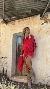 Boho style red tie-dye off-shoulder mini dress with batwing sleeves in rustic setting