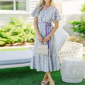 Full view of Bohemian floral maxi dress with V-neck, ruffled sleeves and purple belt