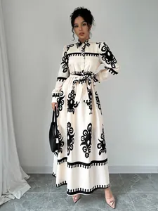 Full-body view of an elegant long-sleeved shirt maxi dress with a striking black graphic print