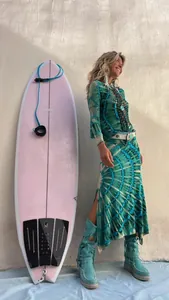 Bohemian mandala tie-dye maxi dress with high slit shown next to a pink surfboard