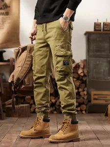 Men's vintage olive green multi-pocket cargo pants in a rugged outdoor mountain style