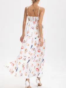 Detailed rear view of white tiered maxi dress featuring colorful seashell and conch prints
