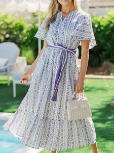Detailed view of bohemian floral maxi dress with V-neck and purple sash belt