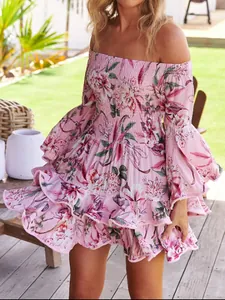 Close-up of pink off-the-shoulder floral dress with ruffled hem and flared sleeves