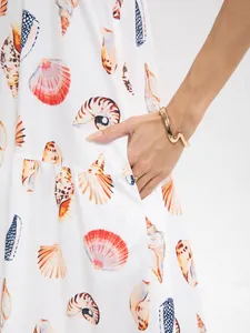 Close-up view of shell print summer dress featuring a functional side pocket detail