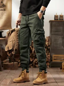 Men's American vintage dark green cargo pants with multi-pockets and jogger cuffs.