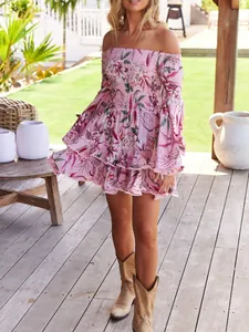 Detail of pink floral off-the-shoulder dress featuring flared sleeves and ruffled skirt