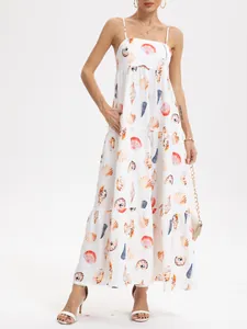 Full-length view of a tiered white maxi dress featuring colorful seashell prints