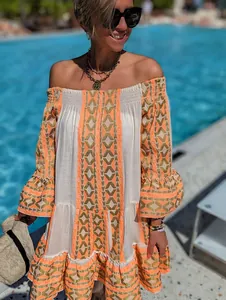 Close-up of bohemian embroidered resort dress with elegant flared sleeves and ruffled hem