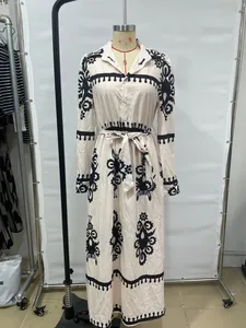Detailed view of long-sleeved shirt maxi dress with ethnic black print and waist tie