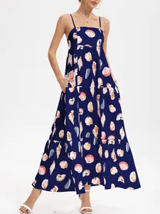 Full view of navy blue tiered spaghetti strap maxi dress with vibrant seashell print
