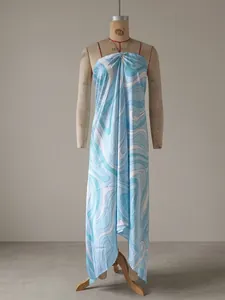 Detailed view of a blue and white swirl print satin halter maxi dress on a dress form