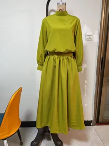 Detail view of women's lime green cotton linen long sleeve top and pleated maxi skirt set