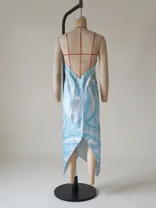 Detailed back view of a blue and white wave patterned satin halter maxi dress on a mannequin