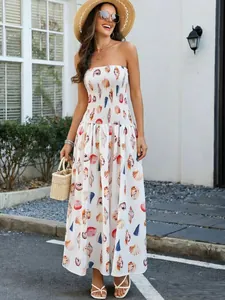 Full-length view of a white seashell print shirred tube top maxi dress for summer.