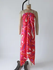 Detailed view showcasing the vibrant swirl print and irregular asymmetric hem of the satin dress
