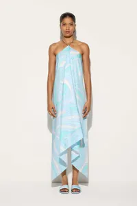 Full-length view of a printed satin halter maxi dress with an asymmetric hemline