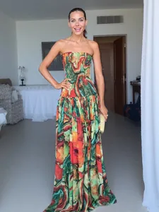 Vibrant abstract print tube top maxi dress with smocked bodice and flowing skirt