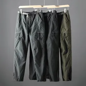 Detailed view of three colors of lightweight quick-dry men's cargo pants on display hangers.