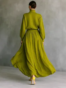 Elegant olive green cotton linen set featuring long sleeve high neck top and pleated maxi skirt