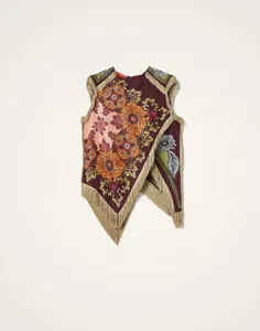 Detailoverzicht van onregelmatige franjes en vintage bloemenpatroon op top