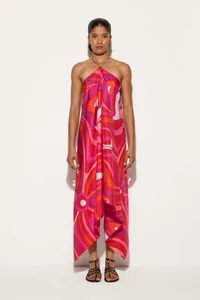 Detailed view of vibrant red swirl print on a satin halter dress with an asymmetrical hem