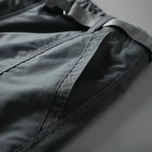 Close-up of quick-dry cargo pants detailing pocket stitching and tactical belt