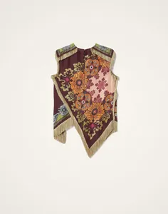 Gedetailleerd achteraanzicht van asymmetrische top met vintage bloemen en franjes